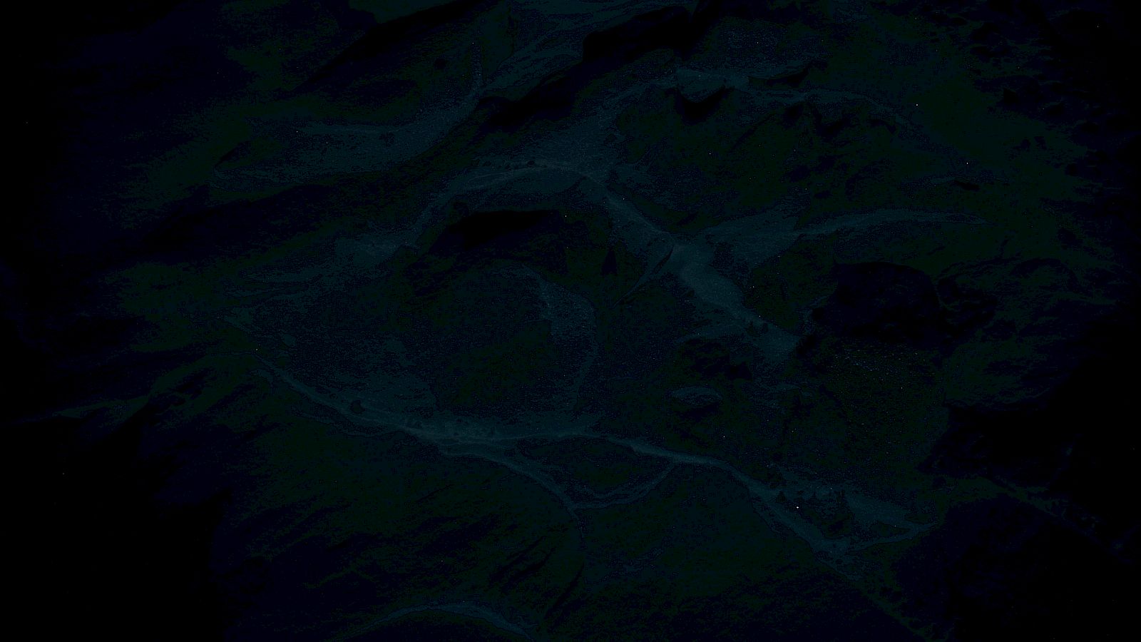 The image appears to show a dark, abstract texture with swirling patterns or formations across its surface.